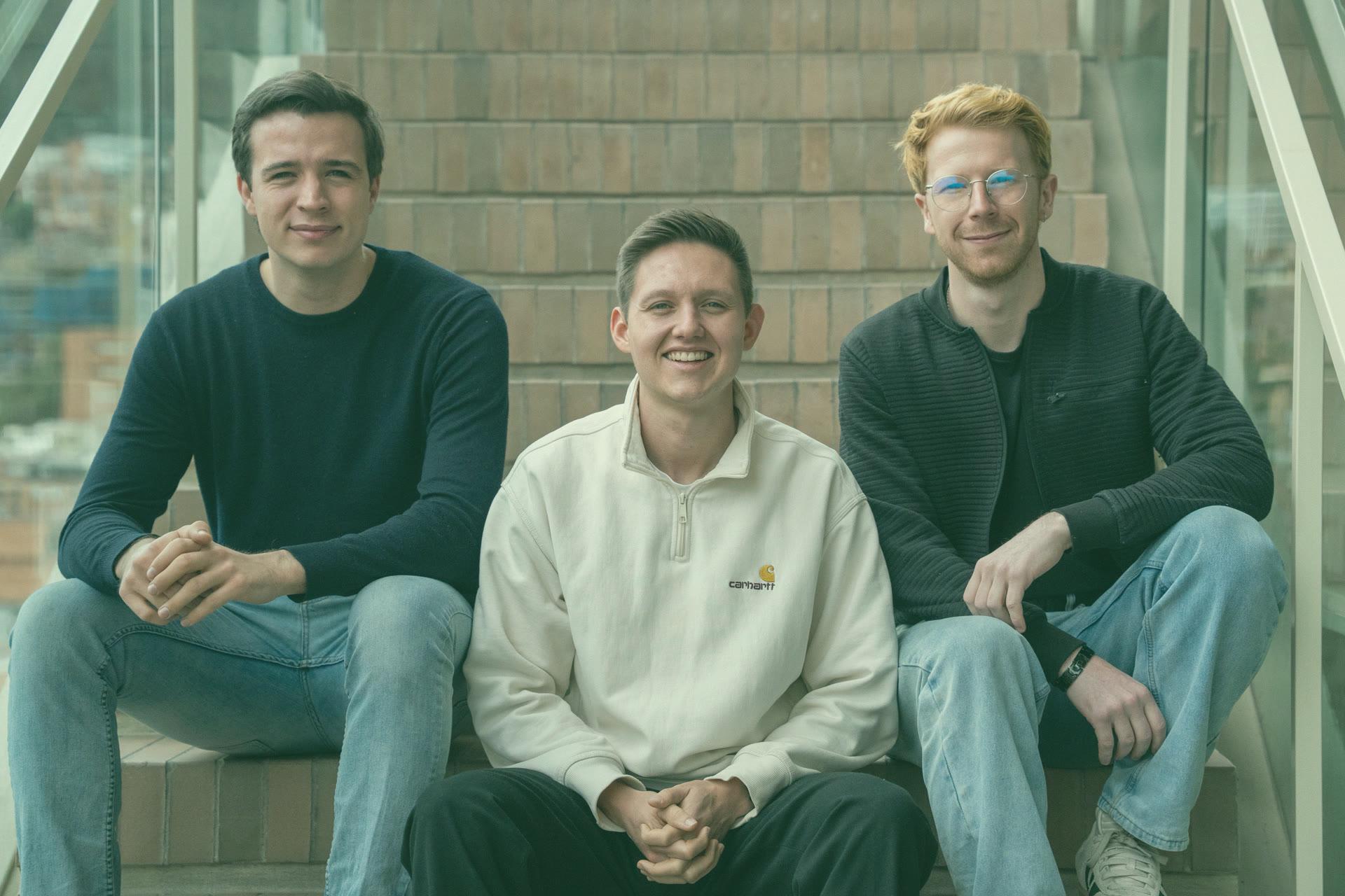 Alex, Sebastian and Daniel sitting on a staircase in the Medellín hacker house